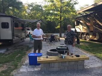 RV pull-through sites with two RVs, picnic table and a paved firepit area — useful view of RV camping setup and site amenities (site photo on campground page).