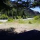 Campsite 2 with trees, river and mountains in background