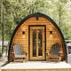 Arched ‘pod’ cabin on a small deck with chairs — highlights alternate cabin accommodation available on the grounds.