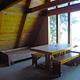 Inside of Steamer Bay cabin with table, benches, and bunks.