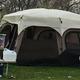 Tent campsite with picnic table and campsite gear on grass — clear photo of tent camping accommodation and site setup.