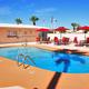 Outdoor swimming pool with loungers and umbrellas on the resort grounds — useful amenity photo (matches pool images on the Capri RV Resort page).