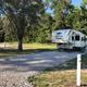Camper parked on gravel back in at Creek Side Resort in Hays, KS