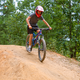 Young rider biking on a wooded trail at Asheboro Jellystone Park