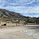 Frijole Horse Corral Campsite with RV parking spaces in the foreground, tent pads, picnic table and restroom are shown.