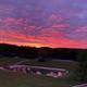 Sunset view over the play pond and fields from the homepage — attractive scenic shot that highlights campground atmosphere and location.