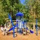 Children's playground on wooded grounds — demonstrates family-friendly onsite amenities featured on the resort page.